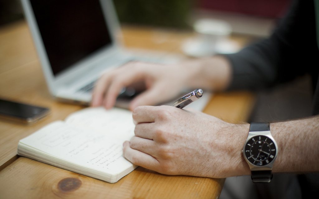 A student working through notes at a desk